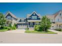 Charming navy blue home featuring a two-car garage and beautifully landscaped front yard at 41 Highveld Ave, Chapel Hill, NC 27516