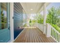 Inviting covered porch with white railings and wood flooring, perfect for relaxing outdoors at 41 Highveld Ave, Chapel Hill, NC 27516
