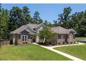 Beautiful home with brick accents and a well-maintained lawn at 413 Great Smokey Mountain Dr, Mebane, NC 27302