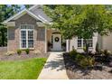 Inviting front entrance with a wreath on the door and potted plants at 413 Great Smokey Mountain Dr, Mebane, NC 27302