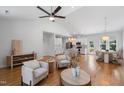 Open-concept living area with hardwood floors, a modern ceiling fan, and seamless flow to kitchen and dining space at 4217 Us-70, Durham, NC 27705