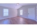 Bright living room features vaulted ceilings, modern ceiling fan, and durable wood-look floors at 4928 Silverdene St, Raleigh, NC 27616