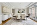 Elegant dining room featuring stylish chandelier, large windows, and sophisticated decor at 500 Walcott Way, Cary, NC 27519