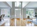 Grand foyer with soaring ceilings, gleaming hardwood floors, and abundant natural light at 500 Walcott Way, Cary, NC 27519