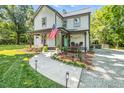 Charming home with a welcoming front porch, a walkway, and landscaping leading to the entrance at 605 W Holt St, Mebane, NC 27302