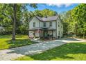 Beautiful home with a metal roof, inviting front porch, walkway, and well-maintained landscaping at 605 W Holt St, Mebane, NC 27302