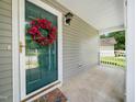 Inviting front porch with a decorative wreath on the door, offering a welcoming entrance to the home at 6228 Saybrooke Dr, Raleigh, NC 27604