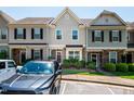 Townhomes feature manicured landscaping, covered entries, and visible house numbers for easy identification at 7809 Lillyhurst Dr, Raleigh, NC 27612