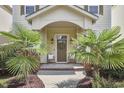 A cozy front porch with a neutral door with wreath and a lovely walkway at 808 Historian St, Raleigh, NC 27603