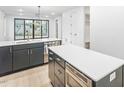 Well-lit kitchen with a double island layout, stainless steel appliances, and dark blue cabinetry at 810 Culpepper Ln, Raleigh, NC 27610