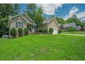 Beautifully landscaped front yard with lush green grass and manicured shrubbery enhancing the curb appeal of the home at 90 Weatherly Dr, Franklinton, NC 27525