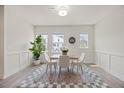 Inviting dining area with natural light, complemented by modern decor and a view of the outdoors at 907 Lake Beacon Way, Raleigh, NC 27606