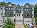 Modern townhome featuring a gray and white color scheme and an attached two-car garage at 907 Lake Beacon Way, Raleigh, NC 27606