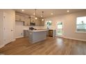 A modern kitchen with stainless steel appliances, gray cabinetry, and center island is perfect for cooking and entertaining at 920 Montague Ave, Durham, NC 27703