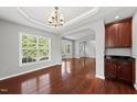 Elegant dining room featuring hardwood floors, updated lighting, and easy access to the kitchen at 9220 Cornwell Dr, Wake Forest, NC 27587
