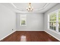 Formal dining room with crown molding, modern lighting, and large windows overlooking the yard at 9220 Cornwell Dr, Wake Forest, NC 27587