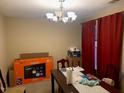 A dining area is set for moving in and relaxing under a chandelier at 929 Morreene Rd # B-24, Durham, NC 27705