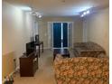 Cozy living room with floral sofas, French doors, and track lighting at 929 Morreene Rd # B-24, Durham, NC 27705