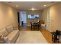 Cozy living room featuring wood floors, neutral walls, and comfortable seating for relaxing and entertaining at 929 Morreene Rd # C-14, Durham, NC 27705