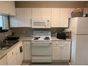 Efficient kitchen featuring white cabinetry and modern appliances at 929 Morreene Rd # D-34, Durham, NC 27705