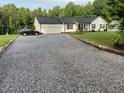 Long gravel driveway leading to a charming home with an attached two-car garage at 956 W Greensboro Chapel Hill Rd, Snow Camp, NC 27349
