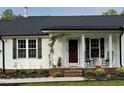 Inviting front porch with rocking chairs, offering a cozy and relaxing outdoor space at 956 W Greensboro Chapel Hill Rd, Snow Camp, NC 27349