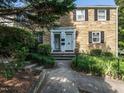 Close up of two-story stone home with well-maintained walkway leading to front door entrances at 979 St Marys St # G6, Raleigh, NC 27605