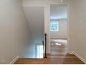 Bright hallway with hardwood floors leads to naturally lit rooms, creating a warm and inviting space at 979 St Marys St # G6, Raleigh, NC 27605
