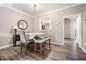Elegant dining room with a table, upholstered chairs, bench, and a view to the kitchen at 1009 Porchside Dr, Apex, NC 27502