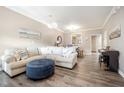 Inviting living room featuring a comfortable sectional sofa and an ottoman, perfect for relaxing at 1009 Porchside Dr, Apex, NC 27502