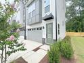 This townhome's exterior showcases a neutral palette, two-car garage, and low-maintenance landscaping at 1015 Regalia Rd # 27, Durham, NC 27713