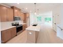 This open-concept kitchen boasts stainless appliances, light wood cabinets, and a spacious island at 1015 Regalia Rd # 27, Durham, NC 27713
