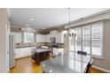 Modern kitchen featuring white cabinetry, stainless appliances, island and hardwood flooring at 112 Salmon River Dr, Durham, NC 27705
