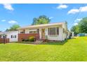 Quaint single-story home featuring a manicured lawn, brick accents, and a welcoming front entrance at 1315 Elder Way, Burlington, NC 27215
