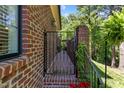 Brick patio entrance featuring a brick wall and an iron gate at 145 Cofield Cir, Durham, NC 27707