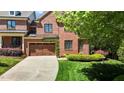 Beautiful brick home with a two-car garage, lush landscaping, and a well-manicured lawn at 145 Cofield Cir, Durham, NC 27707