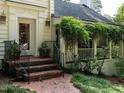 Charming front porch with elegant railings and a brick entryway at 1512 St. Mary'S St, Raleigh, NC 27608
