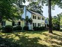 Well-maintained home featuring a lush, green lawn, mature trees, and classic architecture at 1512 St. Mary'S St, Raleigh, NC 27608