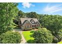 Stunning aerial view of brick home with lush green lawn and mature trees at 164 Avocet Ln, Clayton, NC 27520