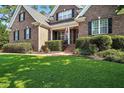 Beautiful brick home with well-maintained landscaping and a welcoming front porch at 164 Avocet Ln, Clayton, NC 27520