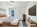 Modern bedroom with a large bed, television, and sleek minimalist décor at 17 Ballard Ct, Durham, NC 27712