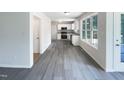Bright kitchen featuring white cabinets, stainless steel appliances, and modern flooring at 17 Ballard Ct, Durham, NC 27712