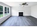Bright living room showcases a fireplace, ceiling fan and large windows at 17 Ballard Ct, Durham, NC 27712