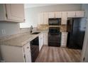 Well-lit kitchen featuring granite countertops, stainless steel appliances, and ample cabinet space at 19 Cheltenham Dr, Clayton, NC 27520
