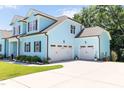 Two-car garage complementing the home's facade and ample driveway space at 2635 High Plains Dr, Fuquay Varina, NC 27526