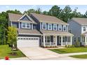 Charming two-story home featuring blue siding, a welcoming front porch, and a convenient attached two-car garage at 2720 Spotted Coral Ct, Apex, NC 27502