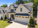 Two-story home with a two-car garage, complemented by green lawns and mature trees at 3057 Eden Harbor Ct, Raleigh, NC 27613