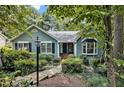 Charming home featuring a stone pathway, lush greenery, and decorative street lamp at 311 Westbrook Dr, Carrboro, NC 27510