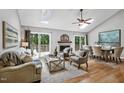 Bright living room features a vaulted ceiling, skylights, fireplace, and seamless access to the outdoor deck at 311 Westbrook Dr, Carrboro, NC 27510