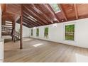 Bright living room featuring natural light, wood floors, skylights, and an open floor plan at 3218 Seven Springs Rd, Hillsborough, NC 27278